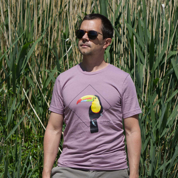 Photoshoot outside on a male model of the keel-billed toucan t-shirt in heather orchid colour.