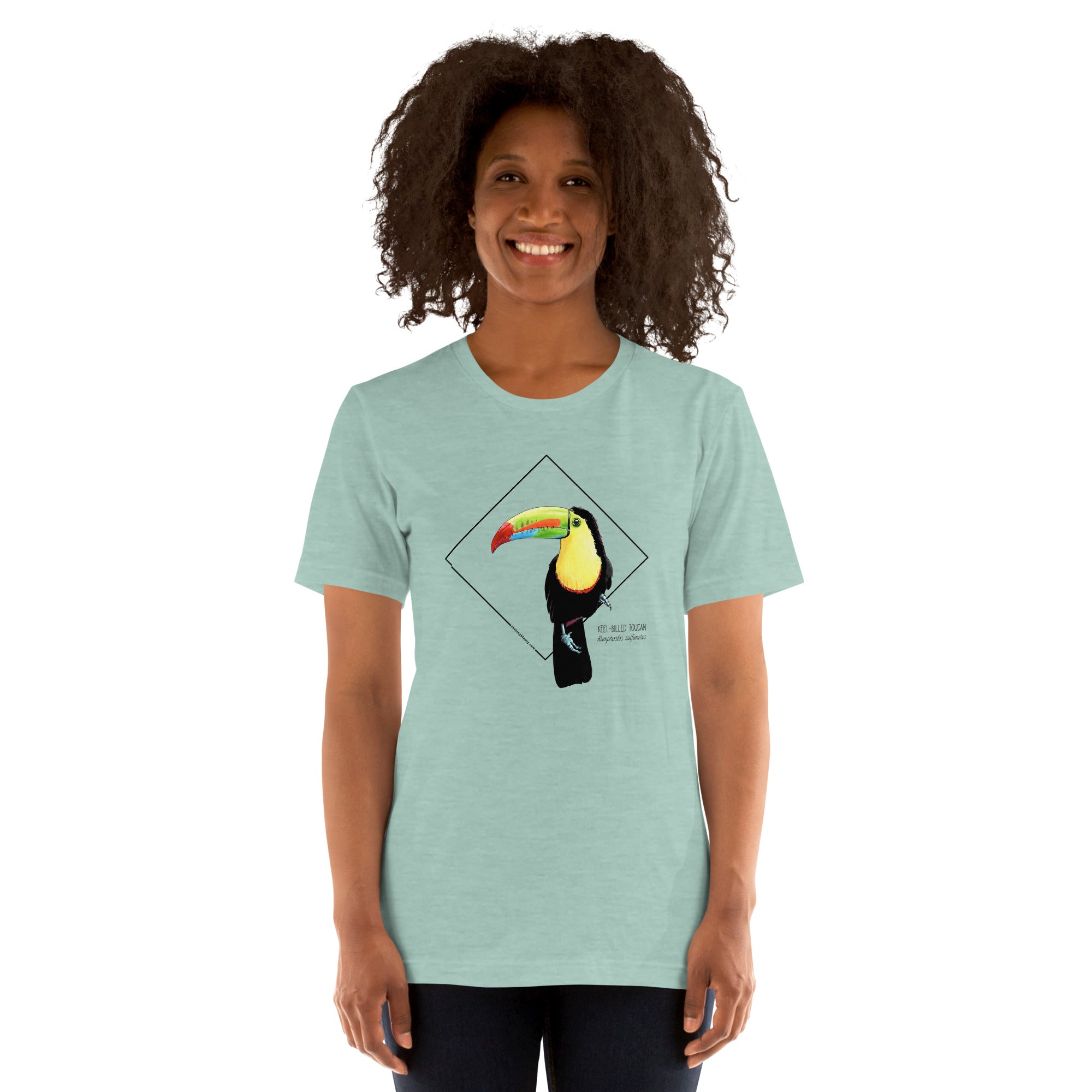 Product mockup showing a female model wearing the keel-billed toucan shirt in the colour heather prism dusty blue.