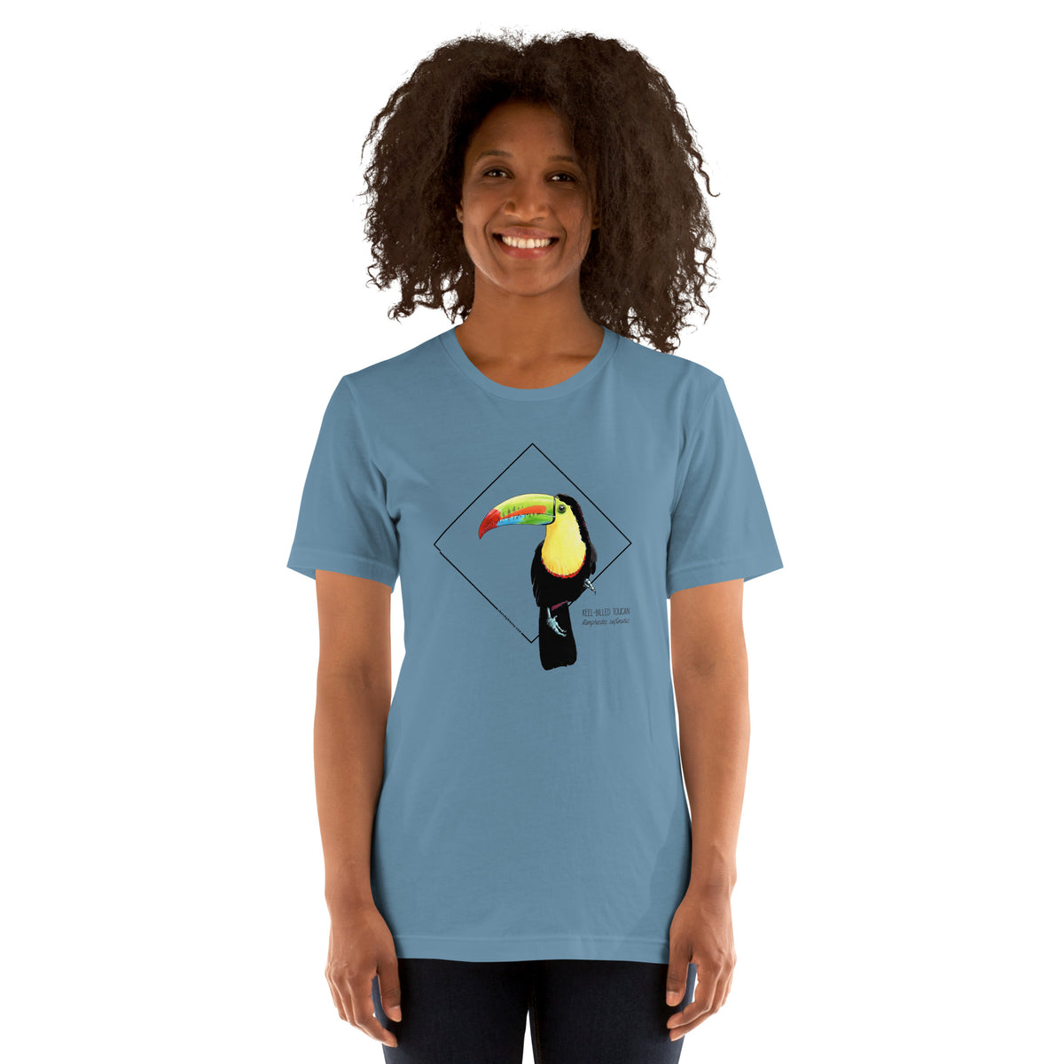 Product mockup showing a female model wearing the keel-billed toucan shirt in the colour steel blue.